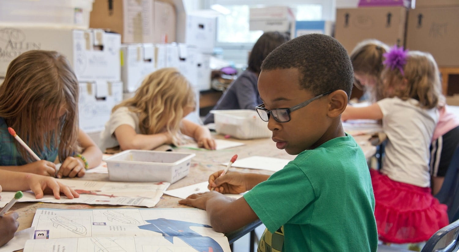 Children in school representing a career in childcare or education with a Childhood Studies degree.